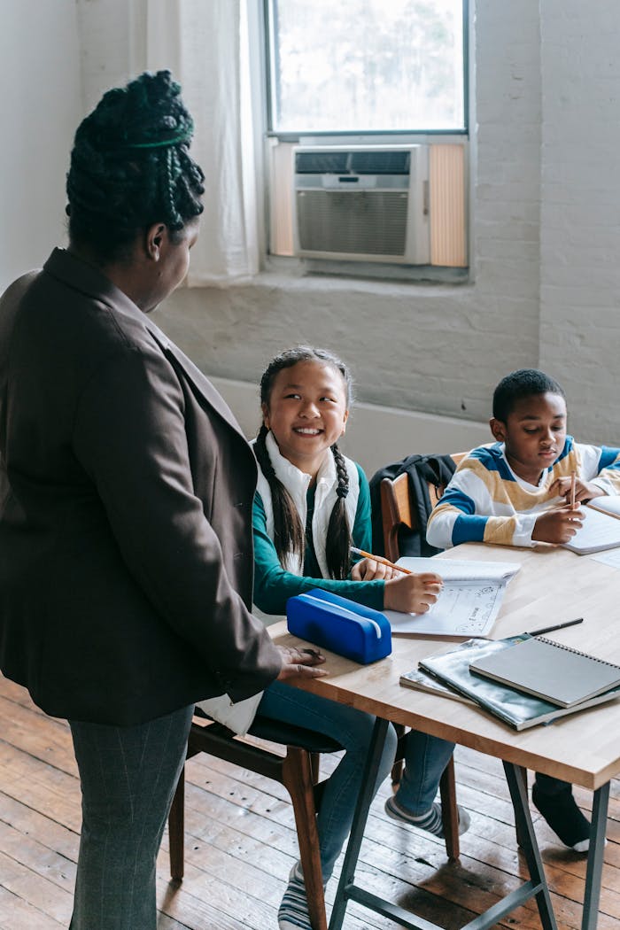Teacher interacting with attentive students in a lively classroom setting.