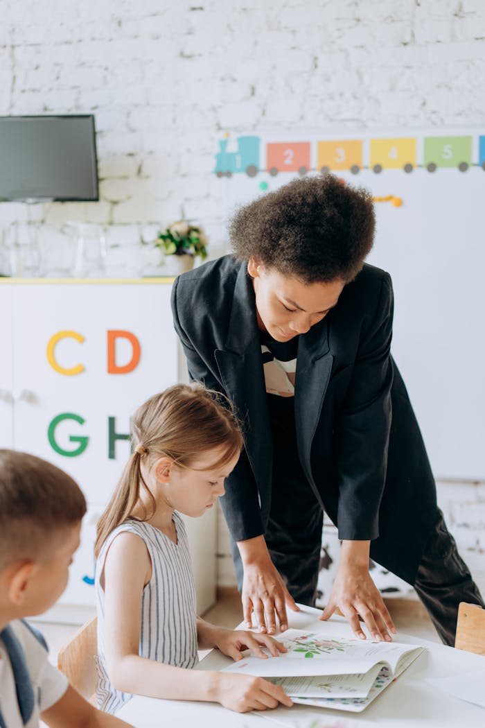 Teacher engaging with children in a colorful preschool classroom setting.
